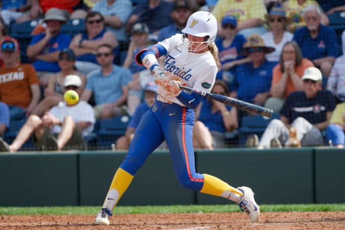Florida Gators right fielder Taylor Shumaker hits against Texas- 1280x853
